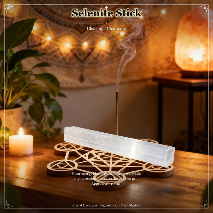 Milky-white selenite stick resting across the wooden sacred geometry grid