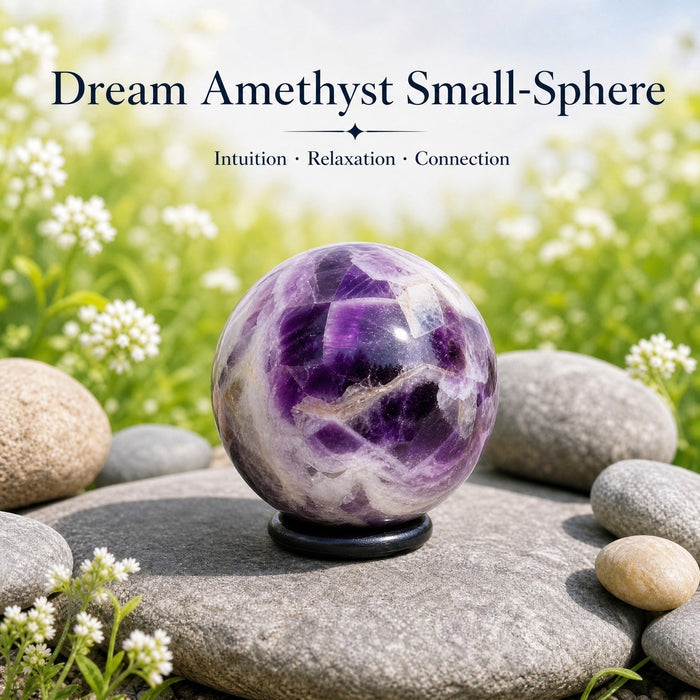 Purple and white banded dream amethyst mini sphere on a stand among pebbles