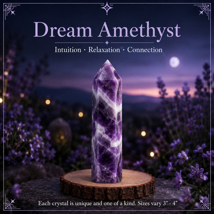 A banded dream amethyst point on a wooden stand at dusk