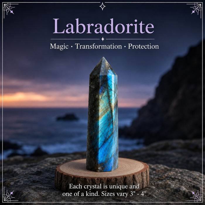 A labradorite point flashing blue on a wooden stand by the sea