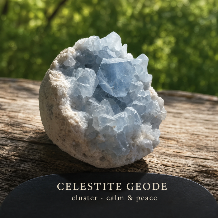 A pale blue celestite geode cluster on a wooden stump