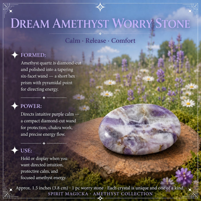 A flat, smooth dream amethyst worry stone in pale purple and white resting on a stone
