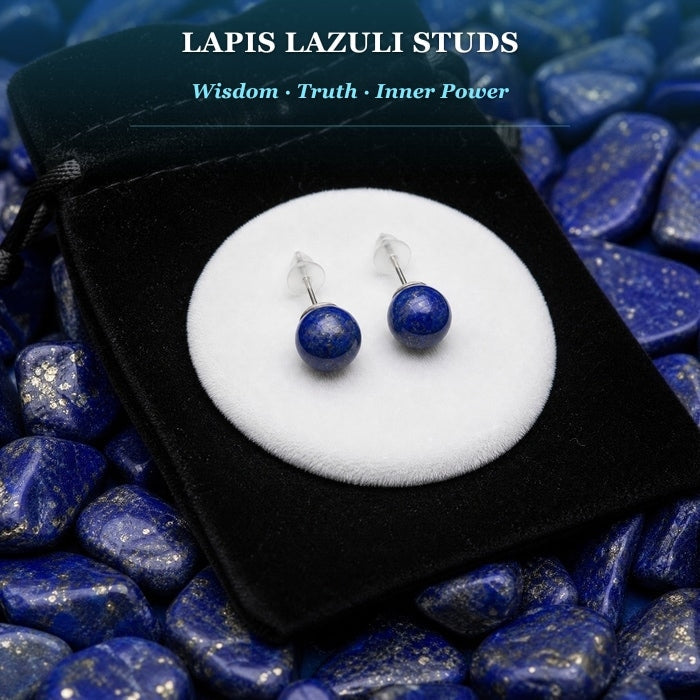 Pair of round deep blue lapis lazuli stud earrings on a white pad
