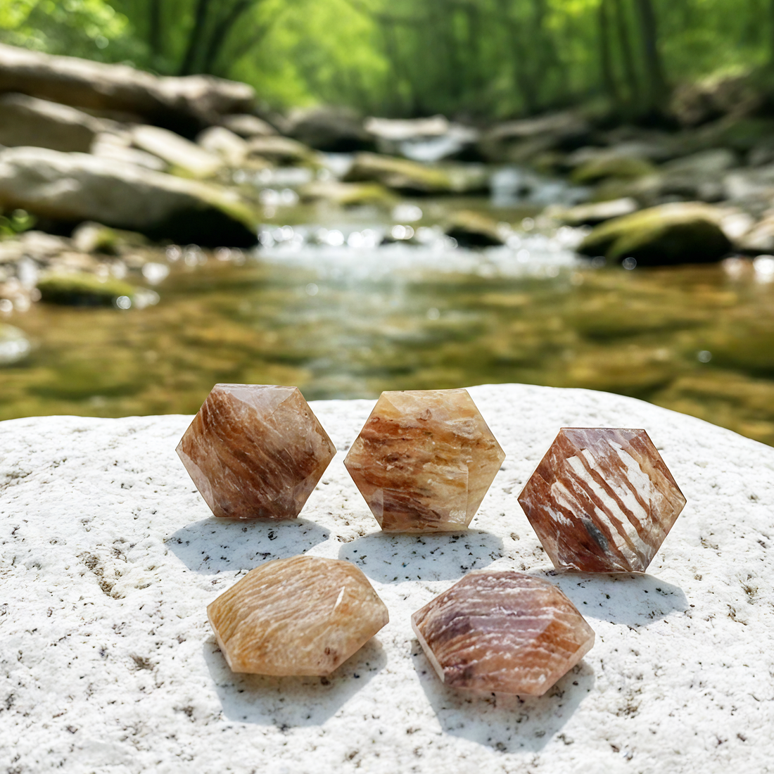 Five faceted rutilated quartz crystals on a white stone, each with its own pattern of copper and smoky bands