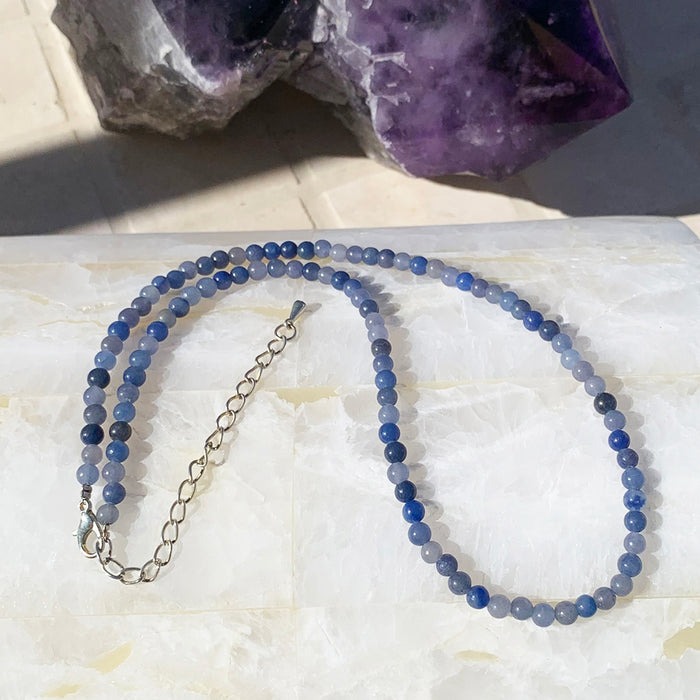 Blue aventurine beaded necklace in deep blue beads on a selenite slab