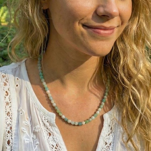 The Caribbean jasper bead necklace worn at the collarbone with a white blouse