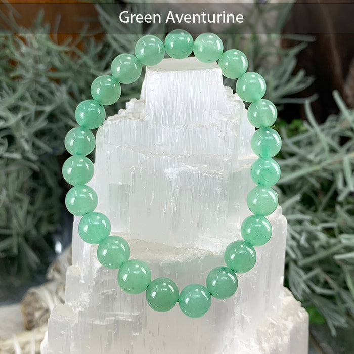 Green aventurine bead bracelet on a selenite tower