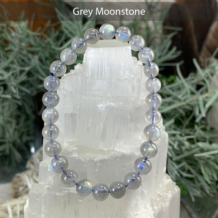 Grey moonstone bead bracelet with a soft silvery sheen on a selenite tower