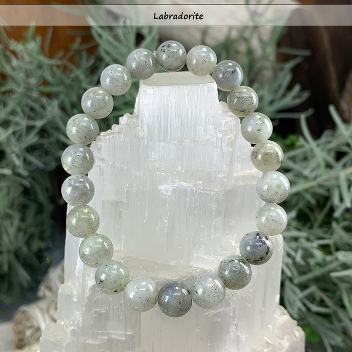 Grey-green labradorite bead bracelet on a selenite tower